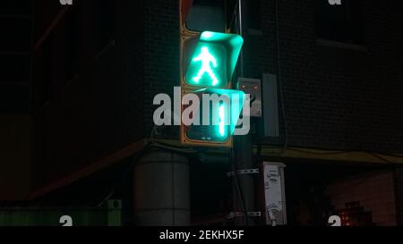 A Traffic Light just before Turning into a Red in the Night Streets of Seoul, South Korea Stock Photo
