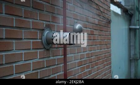 Smoky Ventilation Object on the Red Brick Building's Wall Stock Photo