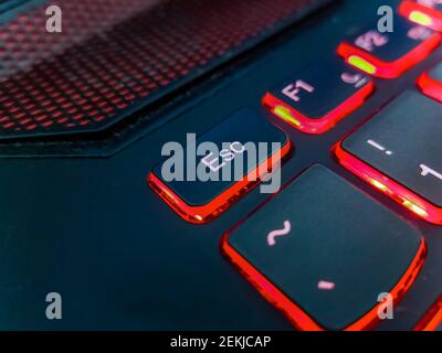 Keyboard of laptop highlighted by red lights Stock Photo