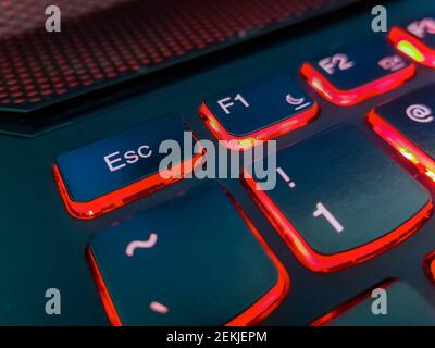 Keyboard of laptop highlighted by red lights Stock Photo