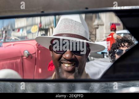 Cuban man driving a vintage car taxi, Havana, Cuba, 2017 Stock Photo