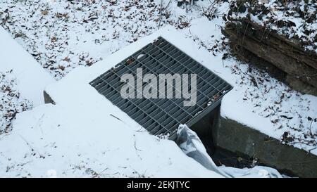 Sewerage on the Winter Snowy Park Stock Photo