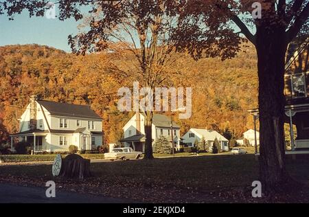 View from a car on a street and white wooden houses. Phoenicia, New York, USA, 1965 Stock Photo