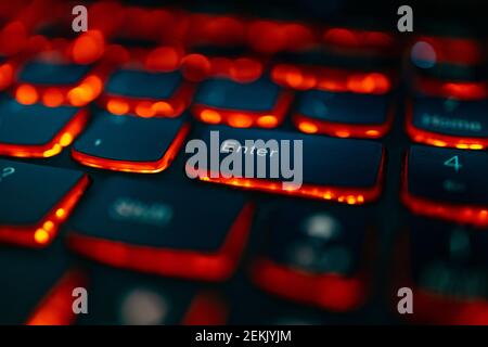 Old laptop with red highlighted keyboard with focus on Enter key Stock Photo
