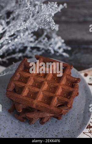 Traditional Belgian waffles with cocoa on wooden background, homemade healthy breakfast. Stock Photo