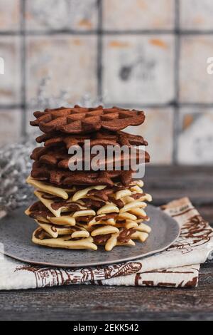 Traditional Belgian waffles with cocoa on wooden background, homemade healthy breakfast. Stock Photo