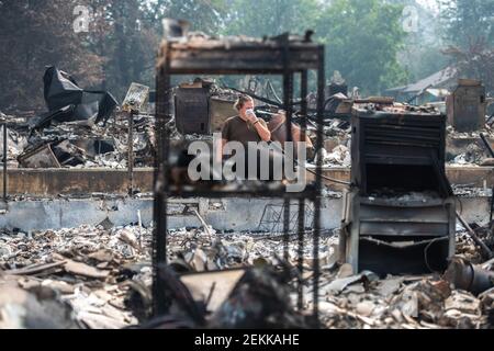 TALENT, ORE - SEPTEMBER 18, 2020: Zach Kuhlow checks the remnants of his house for anything salvagable. His son, who is now 10, was born inside the house. In Talent, about 20 miles north of the California border, homes were charred beyond recognition. Across the western US, at least 87 wildfires are burning, according to the National Interagency Fire Center. They've torched more than 4.7 million acres -- more than six times the area of Rhode Island. Credit: Chris Tuite/imageSPACE/Sipa USA