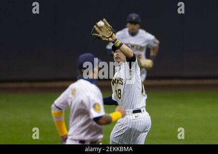 Milwaukee Brewers' Keston Hiura, center, celebrates his run scored against  the Arizona Diamondbacks with teammates Christian Yelich, right, and Brent  Suter, left, during the eighth inning of a baseball game Sunday, July