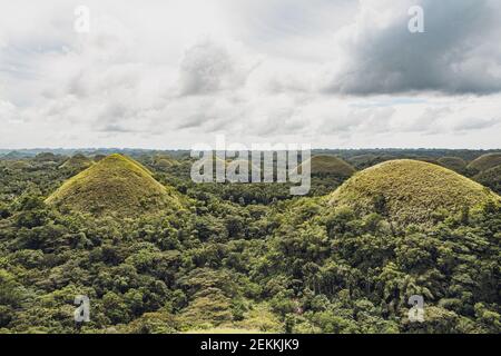 Chocolate Hills with a group of clouds in the sky Stock Photo