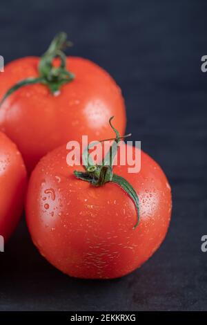 Red fresh tomatoes on a dark background Stock Photo