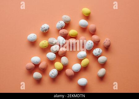 Image of painted quail eggs for Easter isolated on orange background Stock Photo