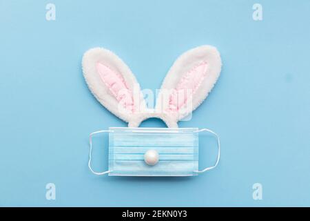 Coronavirus Easter bunny face made from rabbit ears and a protective face mask Stock Photo