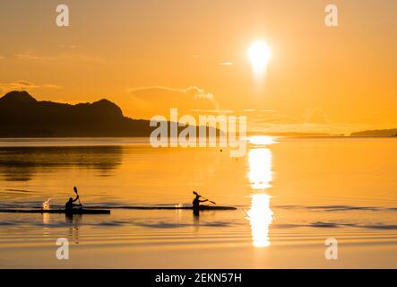 Kayaking at sunset on a fjord in Norway Stock Photo