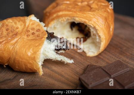 Croissants with chocolate filling on a wooden board Stock Photo