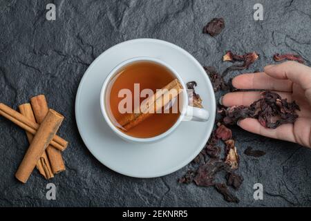 Woman hand holding infusions on a dark background Stock Photo