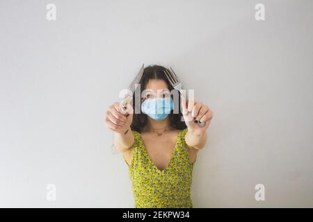 woman with knife and fork in hands and protect mask Stock Photo