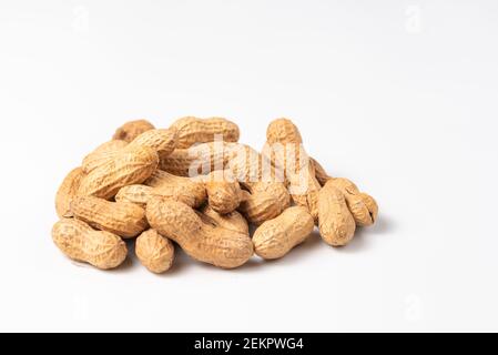 Dried peanuts in closeup isolated on white background. Copy space Stock Photo