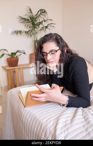 Young woman studying in bedroom Stock Photo
