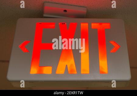 A sign on a ceiling says "EXIT." Stock Photo