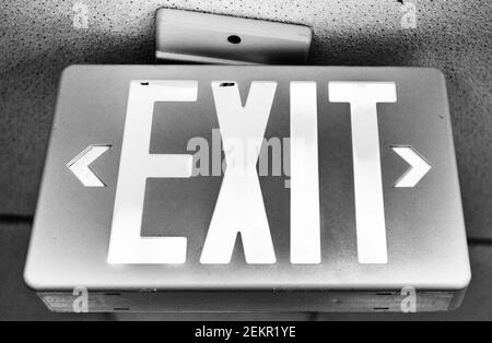 A sign on a ceiling says "EXIT." Stock Photo