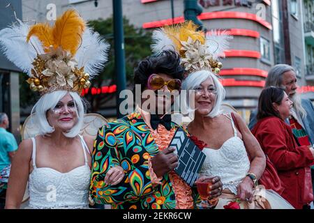 Three middle-aged revellers, two women and one man, dressed in Halloween costumes in downtown New Orleans, Louisiana, USA Stock Photo