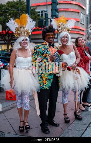 Three middle-aged revellers, two women and one man, dressed in Halloween costumes in downtown New Orleans, Louisiana, USA Stock Photo