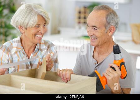 happy senior couple doing diy at home Stock Photo