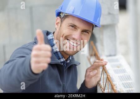 portrait of smiling architect in hardhat sowing thumbs up Stock Photo