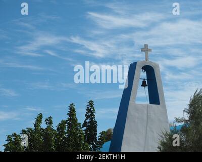 Closeup white bell tower of modern Greek Orthodox church with cirrus clouds on blue sky Stock Photo
