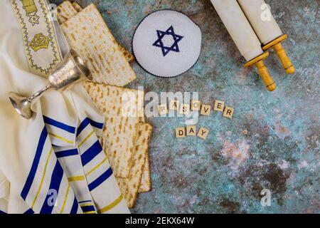 Pesach Passover celebrating symbols of great Jewish family holiday traditional matzah, kippah and tallit, torah scroll Stock Photo