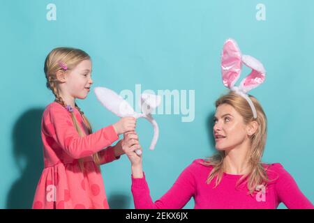 Happy Easter. Family mother and child daughter with bunny ears hare getting ready for holiday. Stock Photo