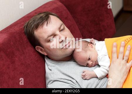 Father with his baby boy on the sofa Stock Photo