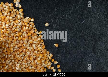 Uncooked corn grains on a dark background Stock Photo