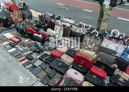 Street vendors on Canal Street selling imitation designer bags in