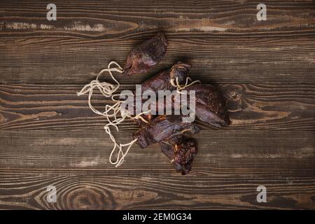 Overhead view of dried jerked deer or venison meat on wooden background Stock Photo