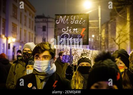 A protester holding a placard saying in spanish 'My country free of Law and Justice (PiS) Party' is seen during the demonstration.  After Polish Const Stock Photo