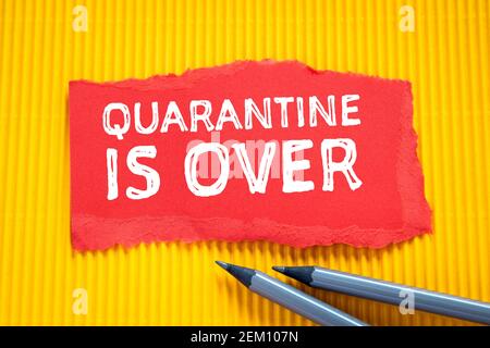 Quarantine is over. Red note paper on a yellow background. Stock Photo
