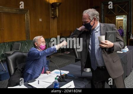 Dr. Eric E. Schmidt, Co-Founder, Schmidt Futures, left, is greeted by United States Senator Tim Kaine (Democrat of Virginia) prior to a Senate Committee on Armed Services hearing to examine emerging technologies and their impact on national security, in the Dirksen Senate Office Building in Washington, DC, USA, Tuesday, February 23, 2021. Photo by Rod Lamkey/CNP/ABACAPRESS.COM Stock Photo