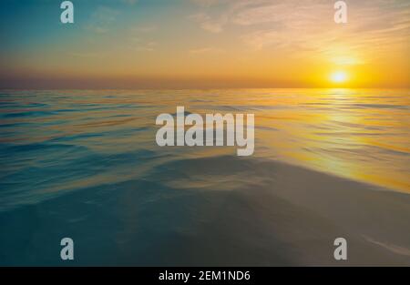 Sunset or sunrise over rippled water Stock Photo