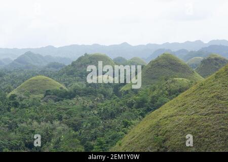 Chocolate Hills with a group of clouds in the sky Stock Photo