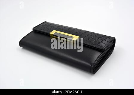 Products made of genuine leather located on a white background. Beautiful female accessory for storing money. Bright and stylish leather black wallet Stock Photo