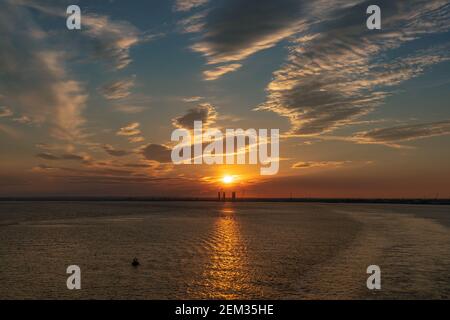 Kingston upon Hull, England, UK - May 22, 2019: The setting sun over the harbour, seen from the River Humber Stock Photo
