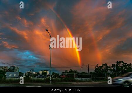 Colorful double rainbow at sunset after the storm Stock Photo