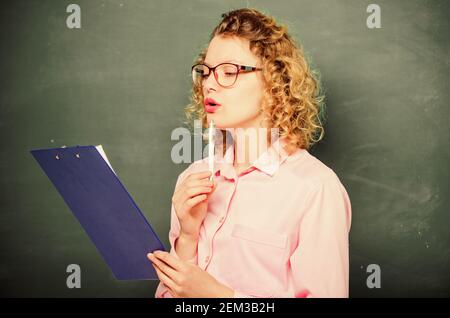 Tutor checking homework. Woman smart lady hold tablet documents. Read personal profile. Estimate essay of applicants. Literature teacher read composition. Read impressing resume. School project. Stock Photo