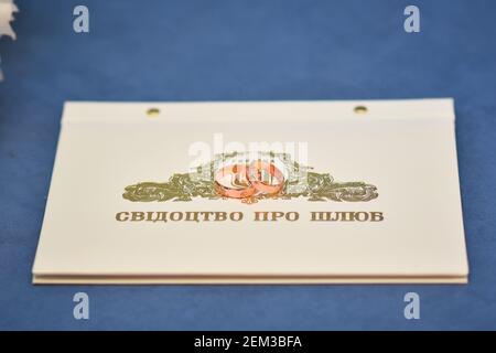 The marriage certificate, two wedding rings are on top. In the Ukrainian language.  Stock Photo