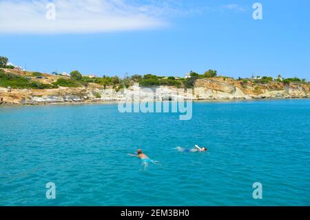 Tourists swimming on Anissaras coast in Crete the largest and most populated of the Greek islands Stock Photo