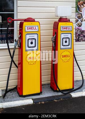 Two vintage Shell petrol pumps on a garage forecourt, Pattishall, Northamptonshire, UK