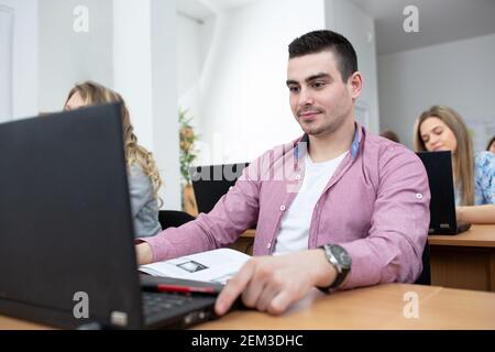 Young man attending university class, student and education concept Stock Photo