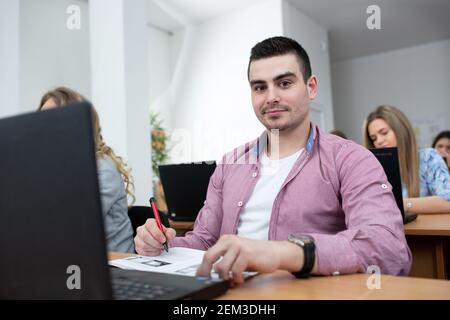 Young man attending university class, student and education concept Stock Photo