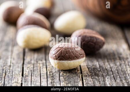 Chocolate easter eggs. Sweet candy eggs on a wooden table. Stock Photo